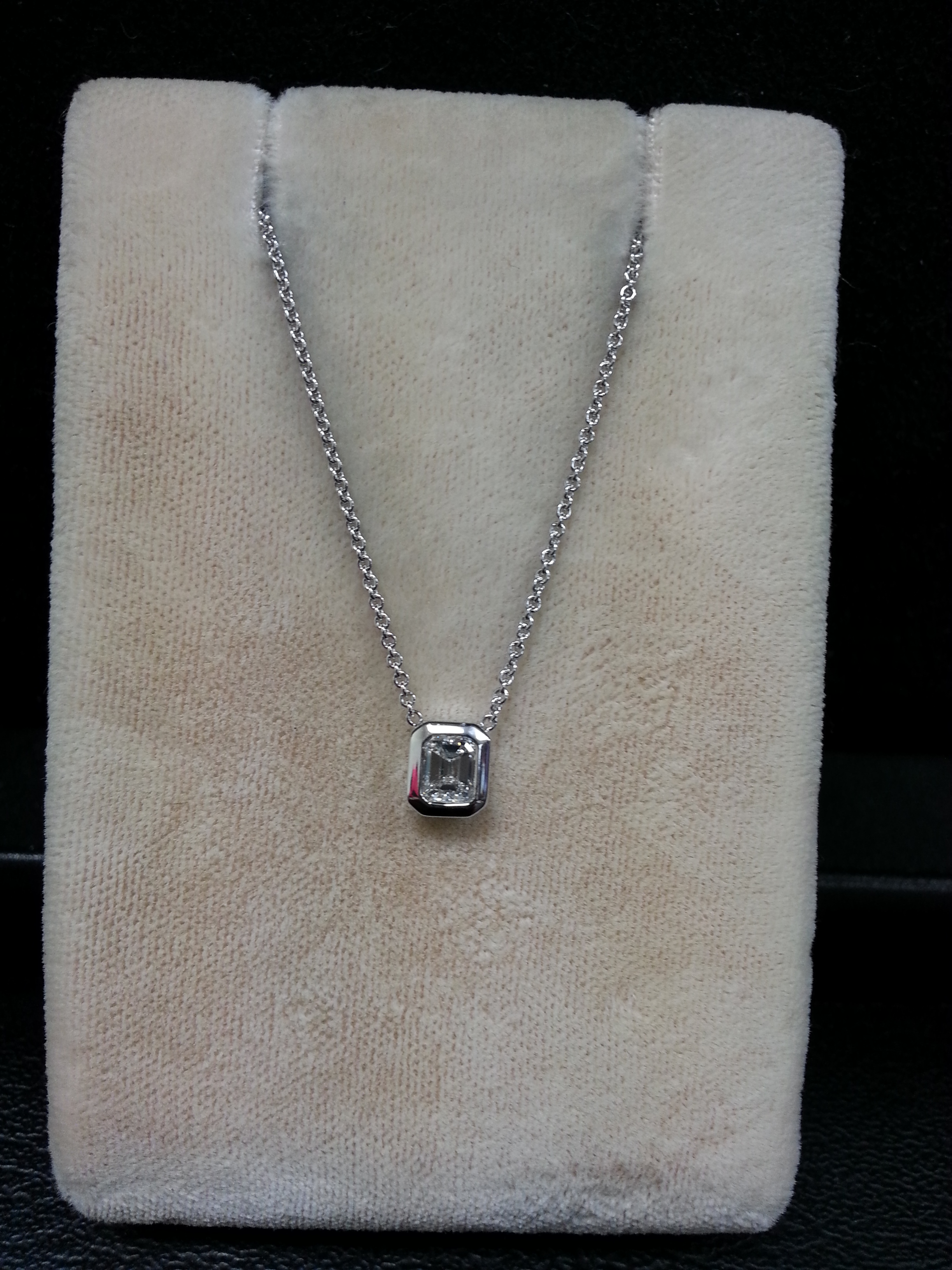 18k White Gold Bezel Set Emerald Cut Diamond Pendant on 18k White Gold Adjustable 16"-18" Chain. E/SI1 D.31ct